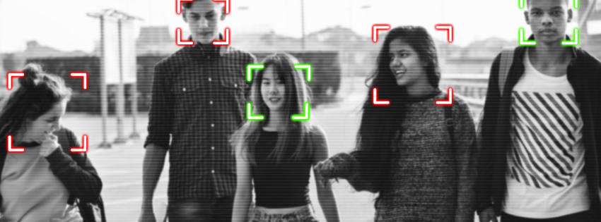 four young people walking with face recognition technology capturing their face