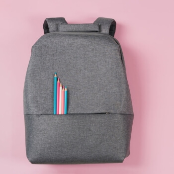 Backpack with pencils in the colors of the Trans Rights flag