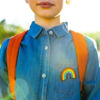 kid with pride flag button