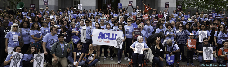 Activists with rally signs of ACLU California