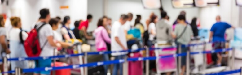 People waiting in line for security screening at an airport