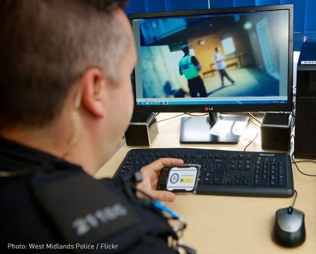 A police officer looking at body camera footage.