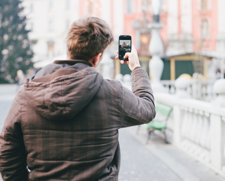 person taking a photo with his mobile phone