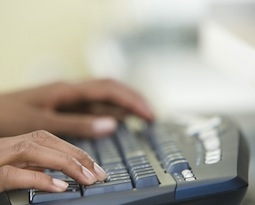 hands typing on a keyboard