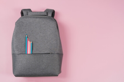 Backpack with pencils in the colors of the Trans Rights flag