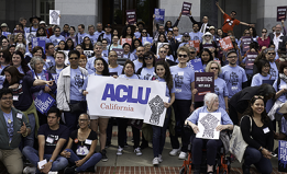 Activists with rally signs of ACLU California