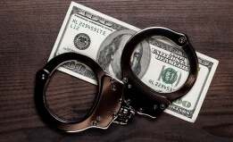 $100 US bill with handcuffs