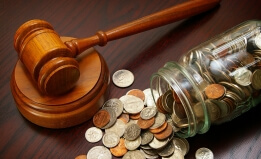 Coins in a jar with a gavel