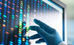 Scientist examining DNA profiles after analytical testing in the lab on a screen monitor