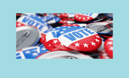 A photo of red, white, and blue buttons that say vote. 